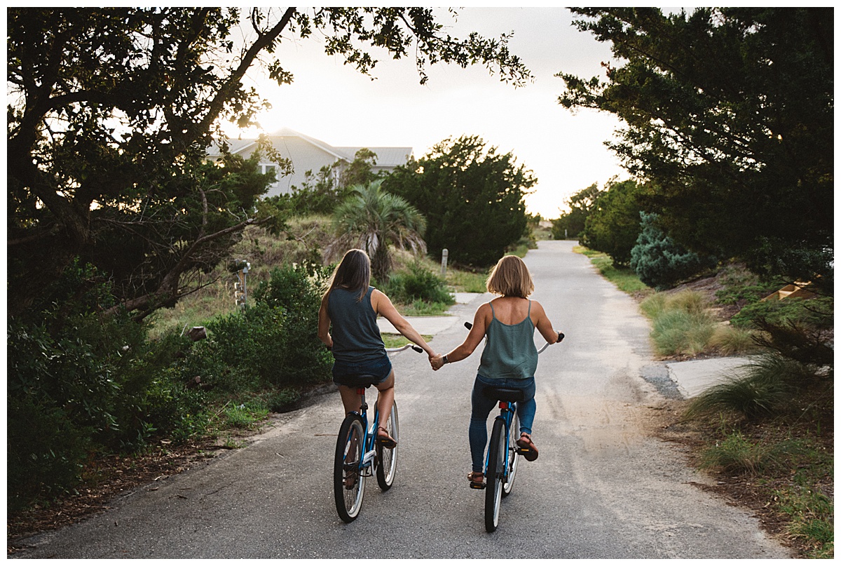 Holding Hands on Bicycles | NC Engagement Photographer